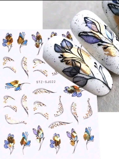 Autocolantes para unhas com desenhos florais coloridos aplicados em unhas brancas com manchas cinzentas