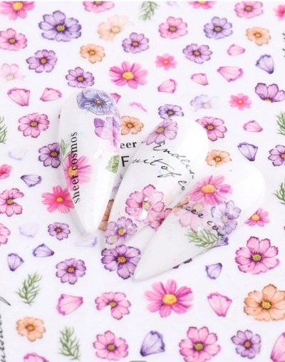 Unhas postiças decoradas com flores coloridas e texto em fundo branco com padrão floral