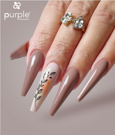 Unha de gel comprida nude com folha preta desenhada e anel com pedras claras