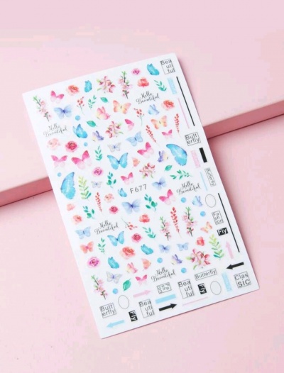 Folha de autocolantes coloridos com borboletas e flores em fundo branco sobre mesa rosa