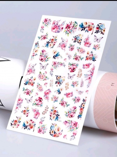 Folha de autocolantes florais e borboletas sobre fundo branco com cilindros ao fundo