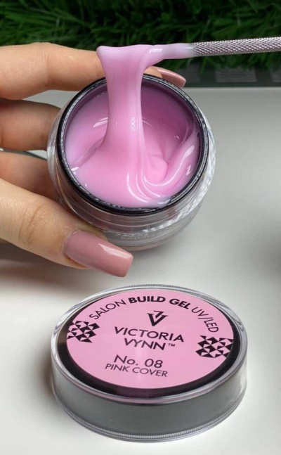 Gel de construção para unhas Victoria Vynn cor rosa com textura viscosa num frasco aberto.