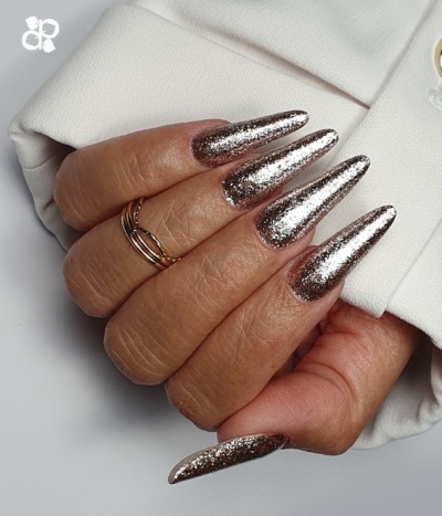 Mãos com unhas longas prata glitter e manga branca