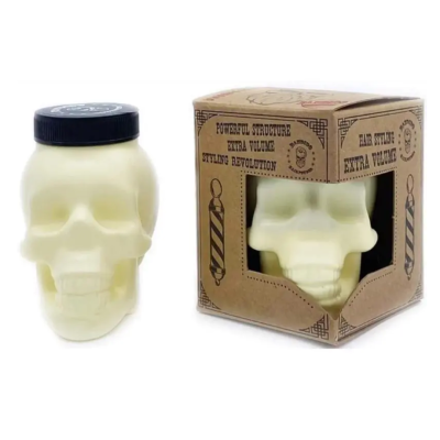 Frasco de produto em forma de caveira com embalagem de cartão castanha e texto