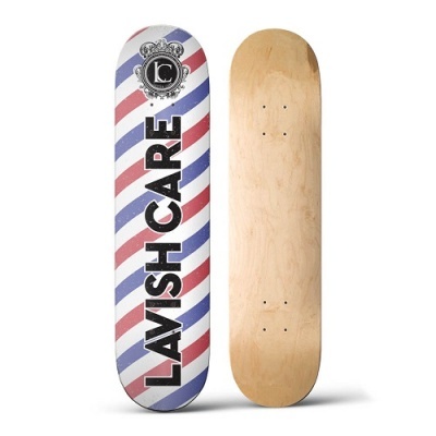 Duas pranchas de skate, uma listrada com texto 'LAVISH CARE' e outra em madeira natural