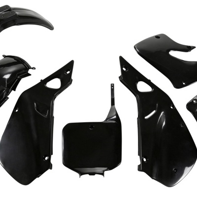 Peças plásticas pretas para moto dispostas em fundo branco