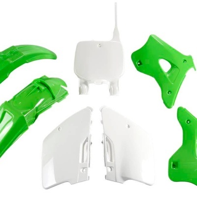 Peças plásticas verdes e brancas para mota sobre fundo branco