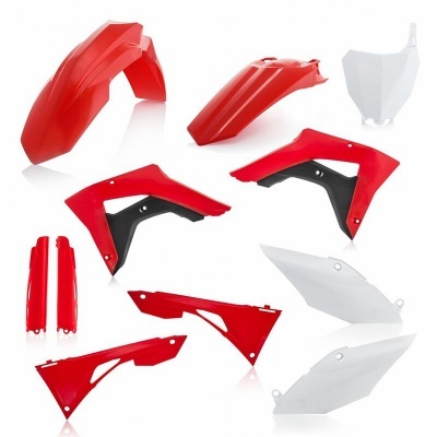 Peças de plástico para moto nas cores vermelho, branco e preto sobre fundo branco