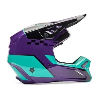 Capacete motocross roxo, verde água e preto com padrão de quadrados e logótipo Fox