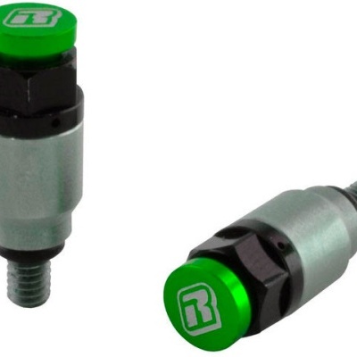 Dois amortecedores pequenos metálicos com tampas verdes e símbolos brancos