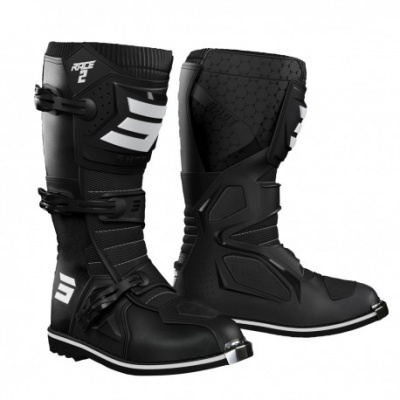 Botas de motocross pretas com proteções e fechos brancos