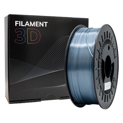 Bobina de filamento 3D azul metálico ao lado de caixa preta com texto FILAMENT 3D