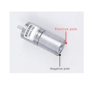 Motor elétrico cilíndrico metálico com etiqueta e indicação de polos