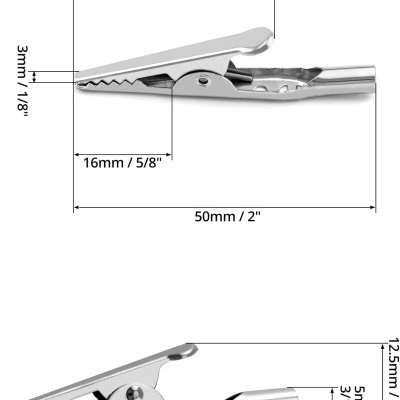 Pinça metálica tipo crocodilo com medidas em milímetros e polegadas.