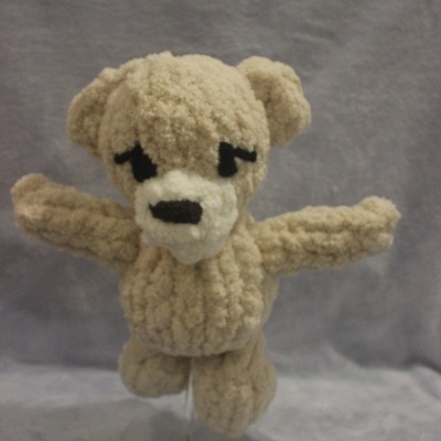 Peluche bege claro felpudo com detalhes brancos e pretos