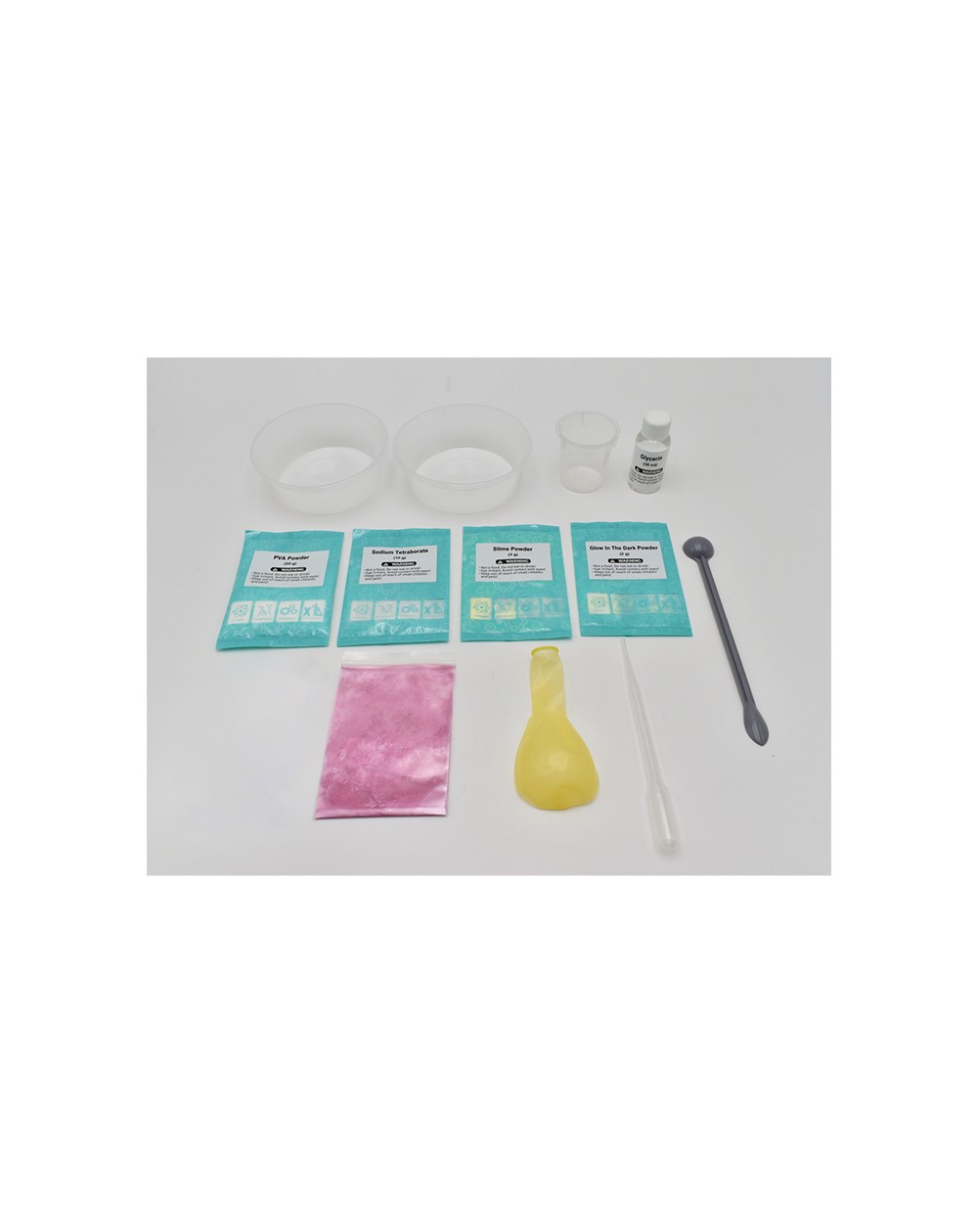 Laboratório de Slime Kit de fabrico de slime com pacotes de pó, recipientes transparentes e acessórios diversos sobre fundo branco.