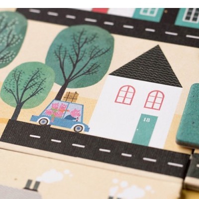 Quebra-cabeças de madeira com ilustração de casa, árvores, carro e texto 'Dretel'