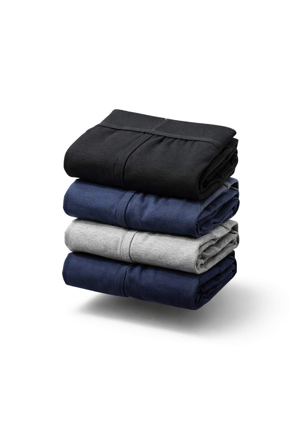 Roupas dobradas em quatro cores diferentes sobre fundo branco