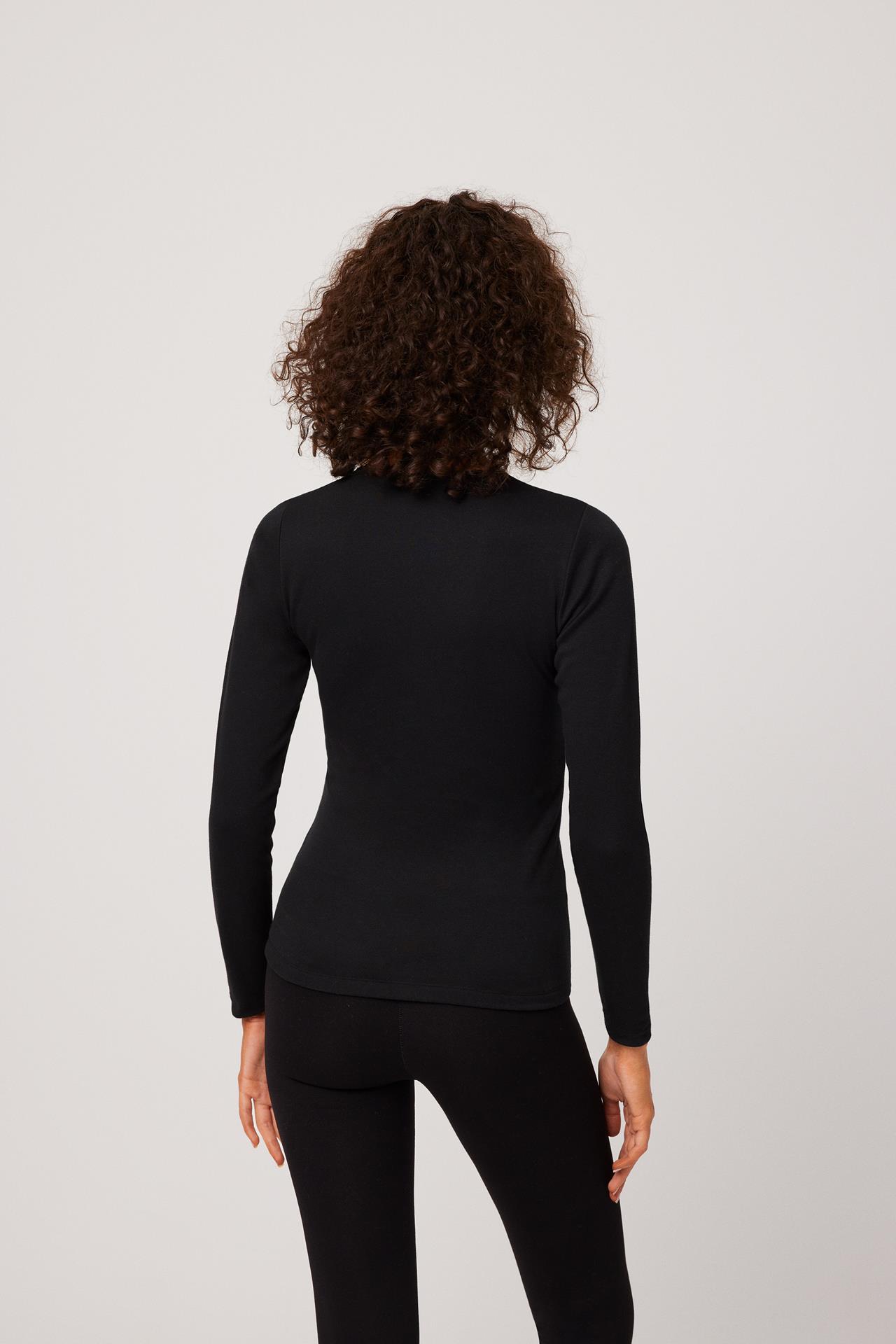 Mulher de costas a usar top preto de manga comprida