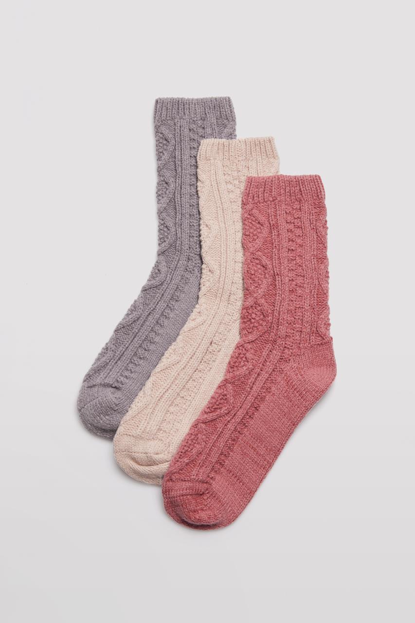 Três meias de malha nas cores cinza, bege e rosa envelhecido com padrão trançado