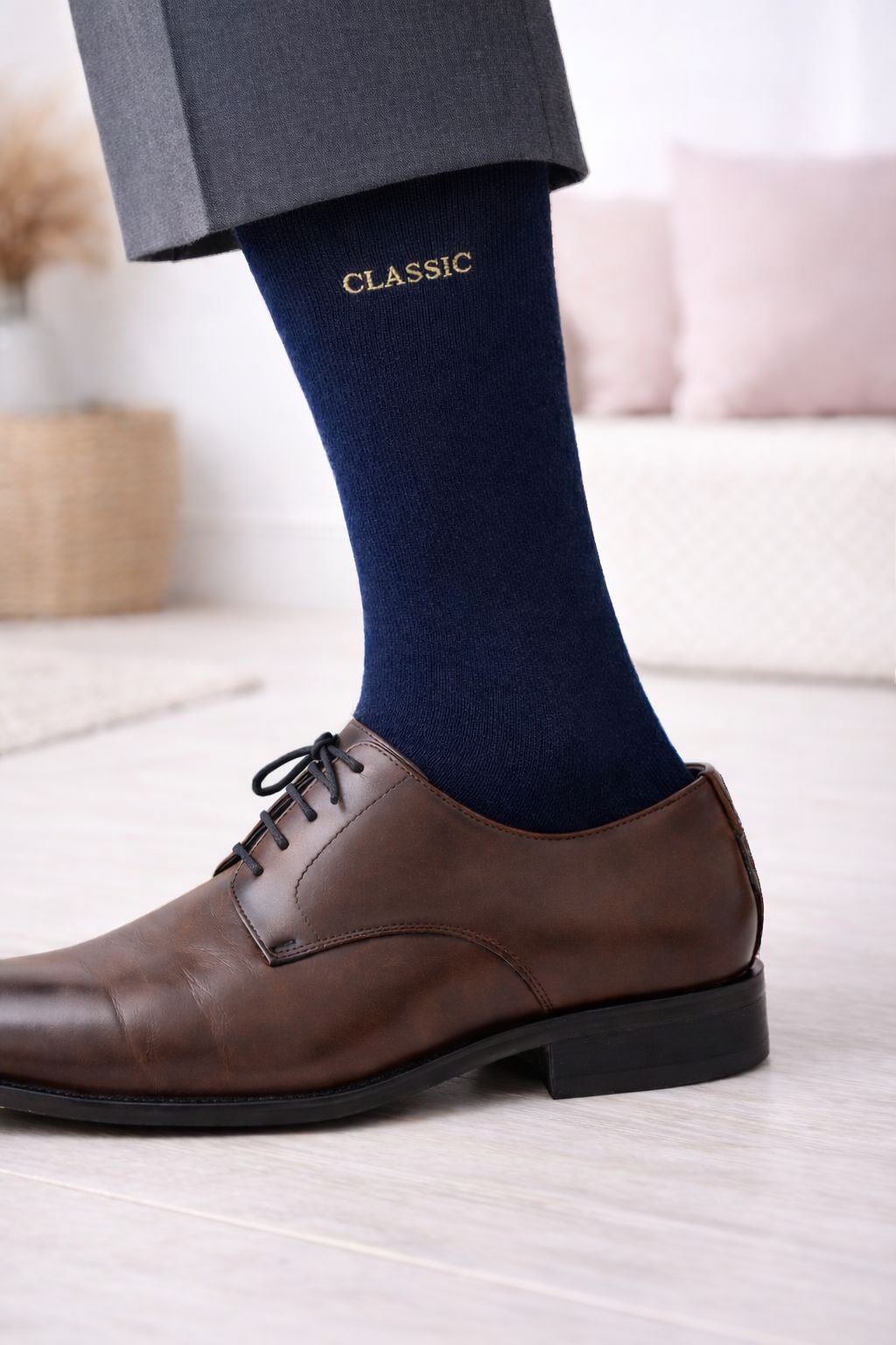 Meia azul escura com palavra CLASSIC usada com sapato castanho de couro e calças cinzentas