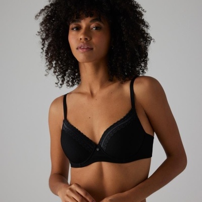 Conjunto de roupa interior feminina preta com renda, mostrado por modelo contra fundo cinzento