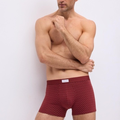 Modelo masculino de boxers vermelhos com padrão de pequenos pontos brancos