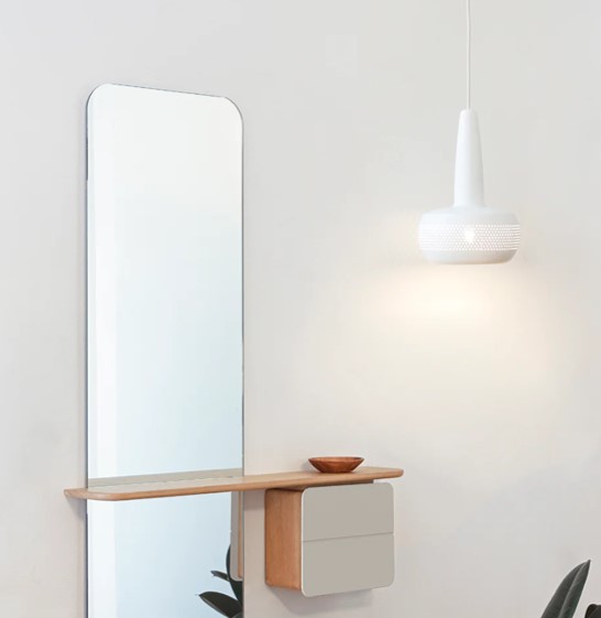 CLAVA Espelho vertical com prateleira de madeira e gavetas cinzentas na parede branca, com luminária pendente branca ao lado