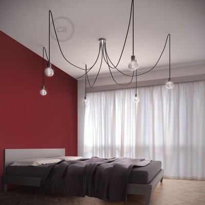 Quarto moderno com cama cinza e lâmpadas penduradas