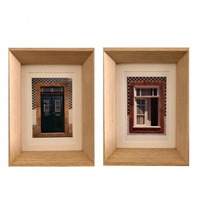 Dois quadros com fotografias de porta verde e janela branca com molduras de madeira clara