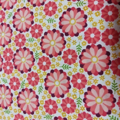 Tecido estampado com flores rosa, vermelho, amarelo e folhas verdes sobre fundo branco
