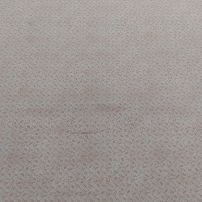 Superfície têxtil bege claro com padrão de letras cor-de-rosa claro