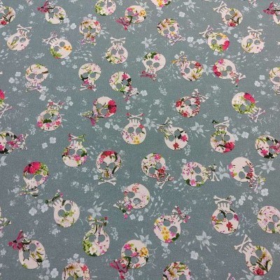 Tecido com padrão de caveiras florais coloridas