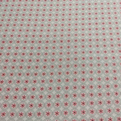 Tecido branco com padrão repetido de círculos cinza e estrelas vermelhas no centro