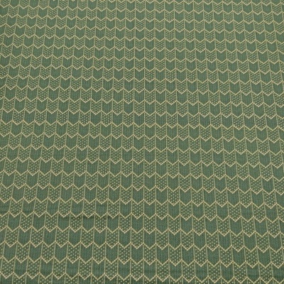 Tecido verde com padrão geométrico de setas brancas