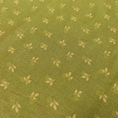 Tecido verde com padrão de folhas amarelas pequenas