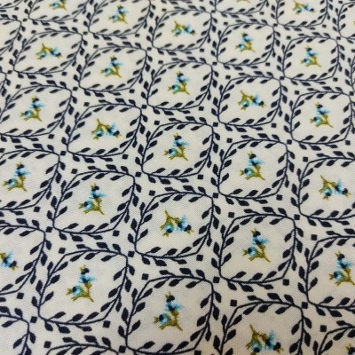 Tecido com padrão de quadrados com ramos e flores pequenas azul e amarelo