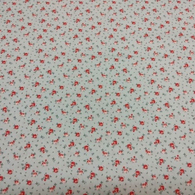 tecido branco com pequenas flores vermelhas e folhas cinzentas