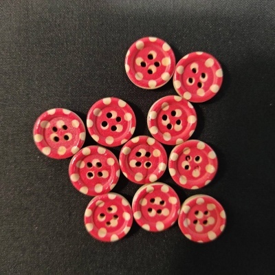 Dez botões vermelhos com pontos brancos sobre fundo preto