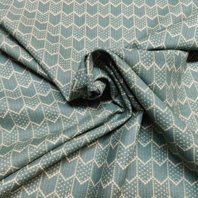 Tecido azul esverdeado com padrão branco zig-zag