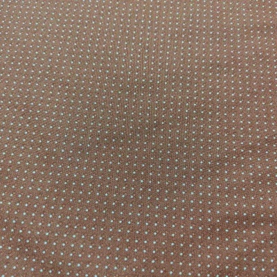 Tecido castanho com padrão de pequenos pontos brancos