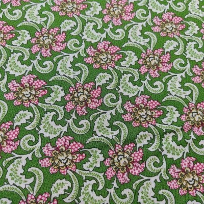 Tecido estampado verde com flores rosas e amarelas e folhas brancas