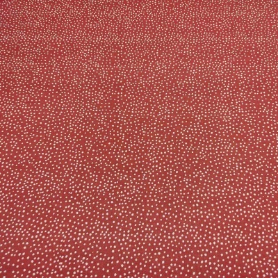 Tecido vermelho com pequenos pontos brancos dispersos