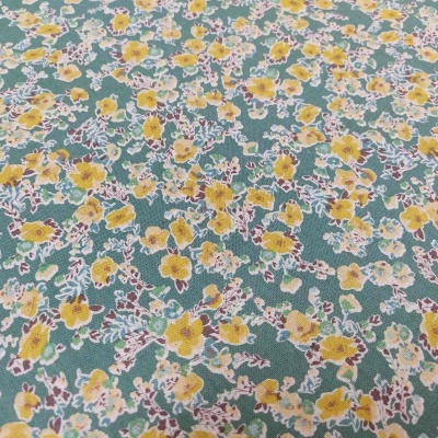 tecido verde com padrão floral amarelo e castanho