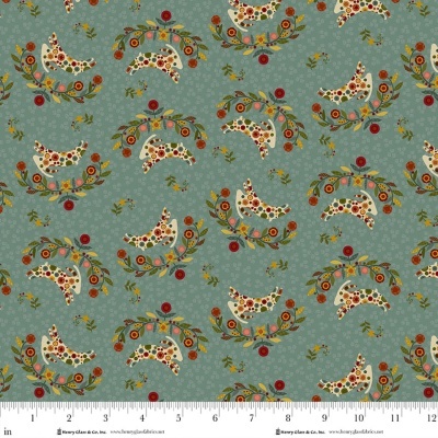 Tecido estampado com coelhos e flores coloridas num fundo verde-azulado.