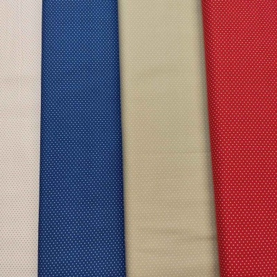 tecidos coloridos com padrão de pequenos pontos brancos em branco, azul, bege e vermelho