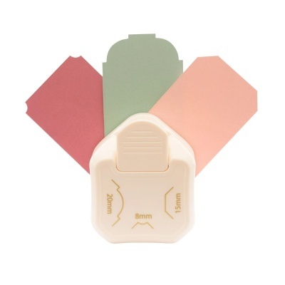 Furador de papel branco com papéis coloridos