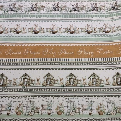 Tecido decorativo com padrões de Páscoa em verde, castanho e branco.