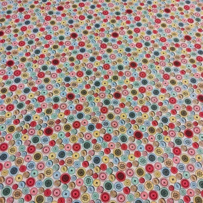 Tecido estampado com botões coloridos em padrão repetitivo