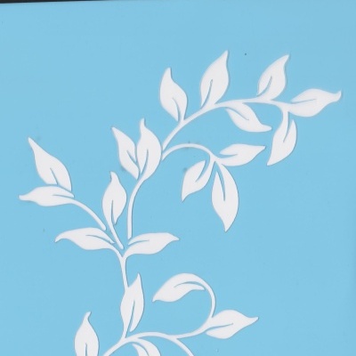 Stencil plástico azul com padrão de folhas brancas, embalagem preta com texto